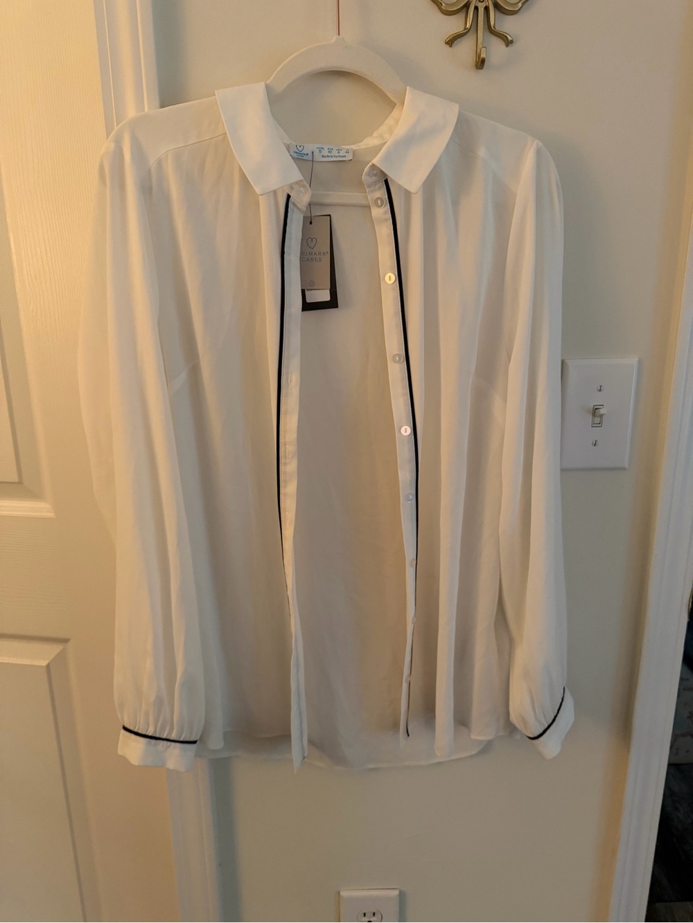 White button down blouse with black piping
